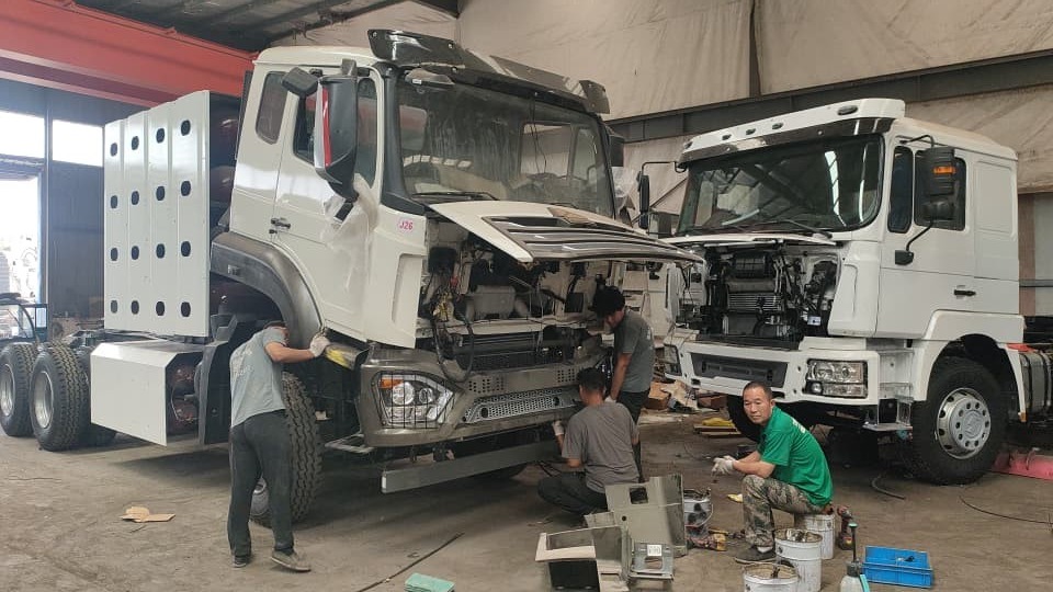 Technicians assembling truck cabs